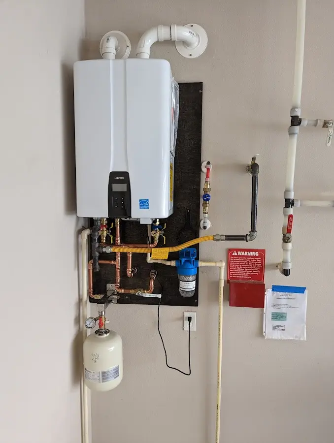 Professional plumber installing copper piping in a New Richmond home